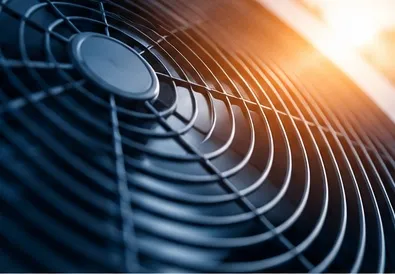 Close-up of the fan grille on an air conditioning outdoor unit