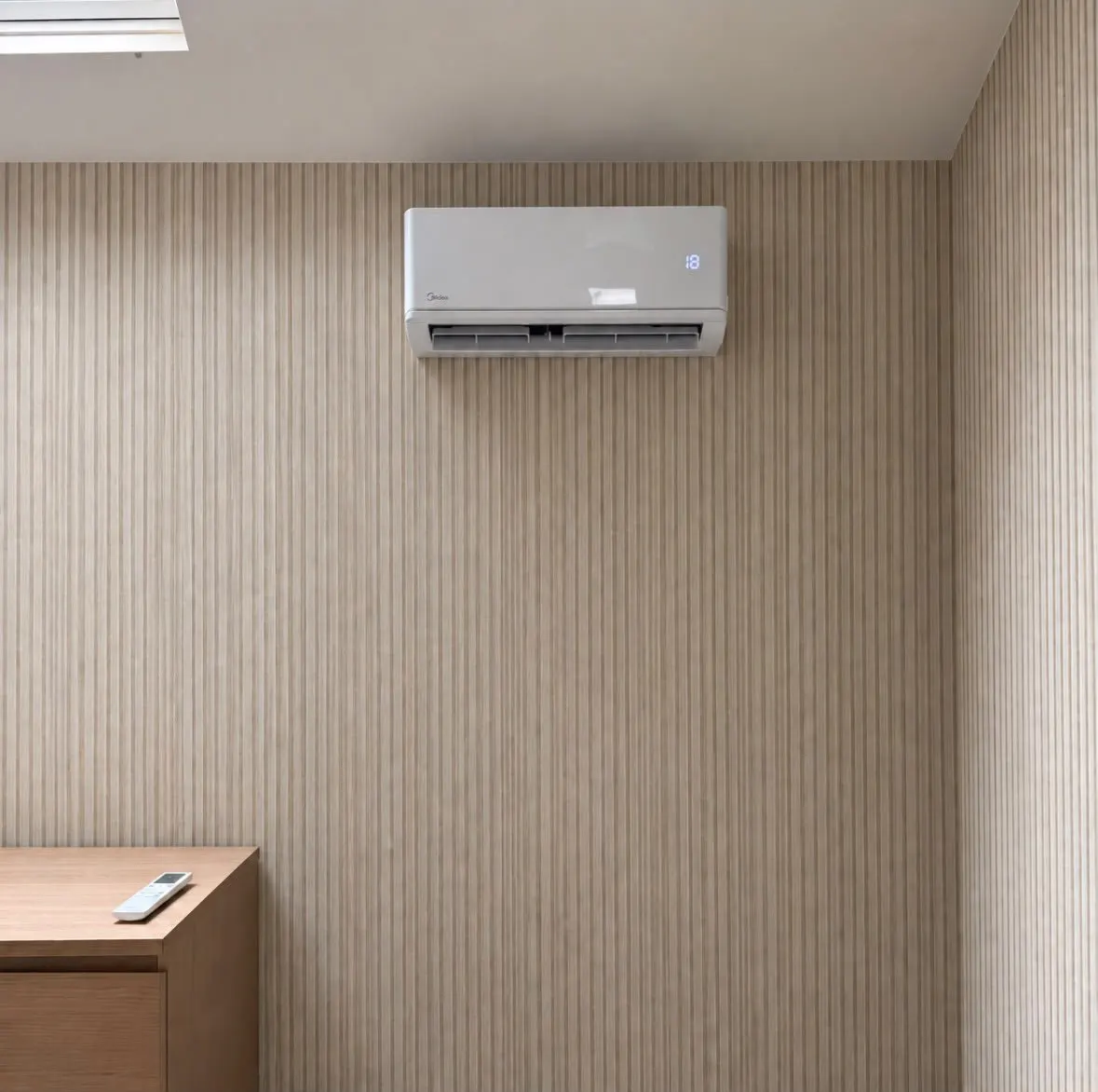 Wall-mounted air conditioning unit on a slatted panel wall above a wooden sideboard